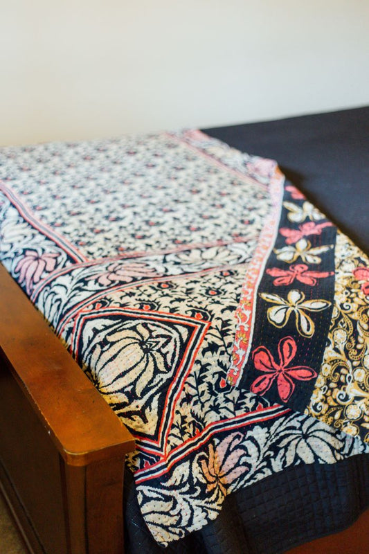 A black and white Kantha floral throw blanket