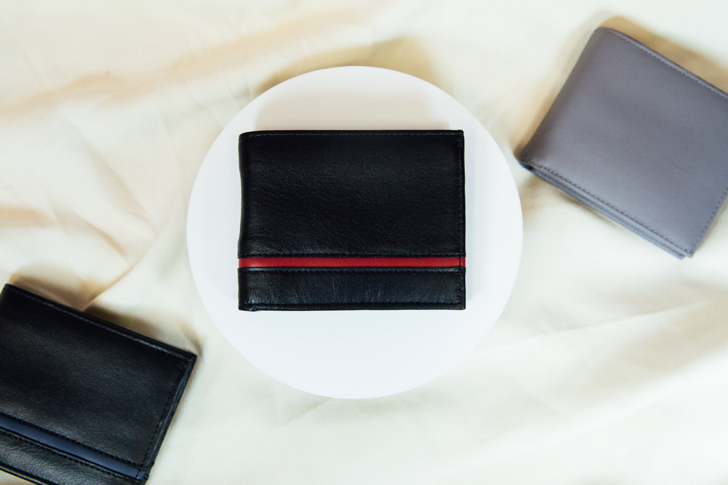 An exterior view of the black and red Carry-It-All Leather Bifold Wallet
