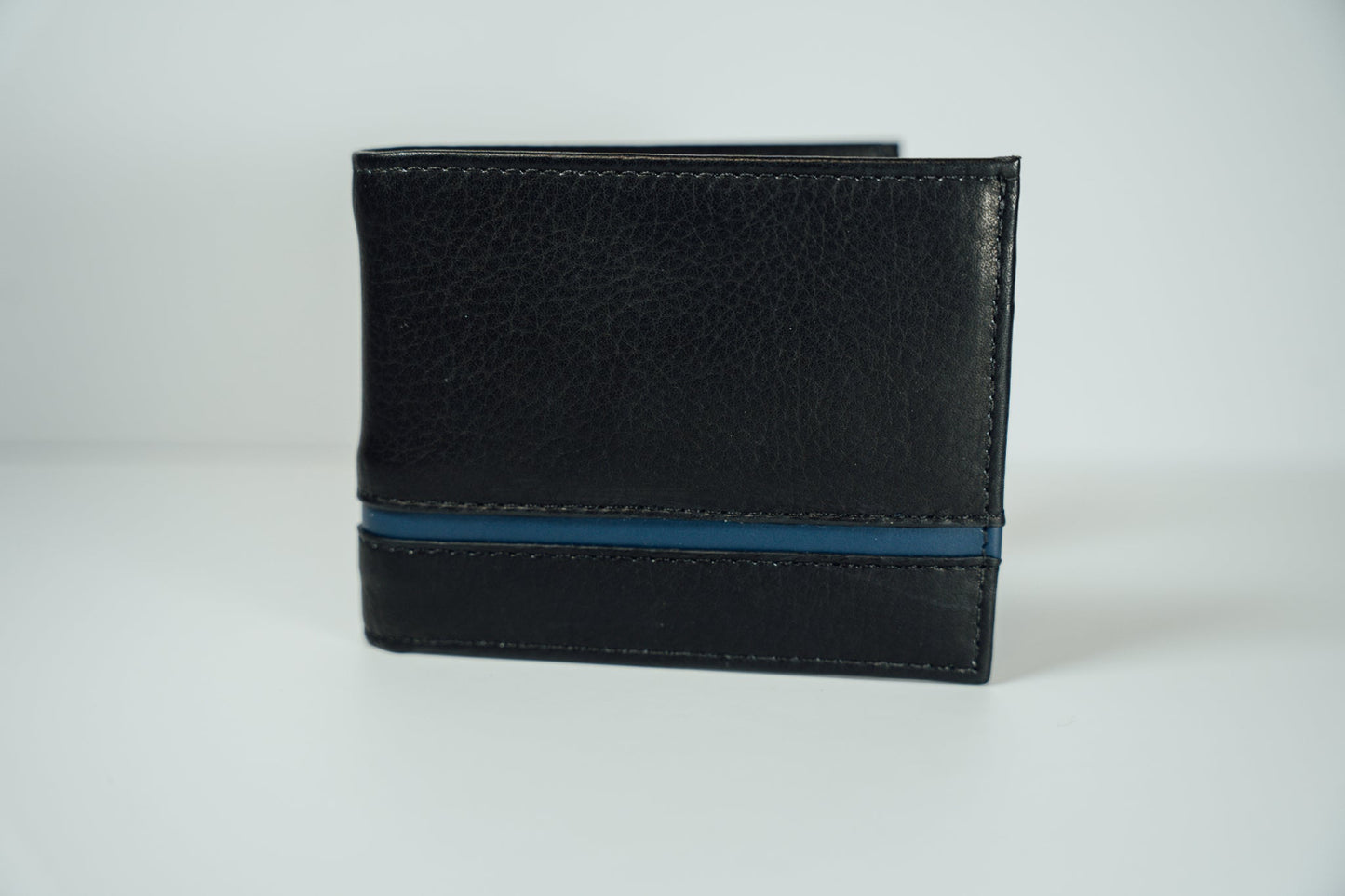 The exterior view of the black and blue Slim Bifold Leather Wallet from John Candor at Hope's Gate