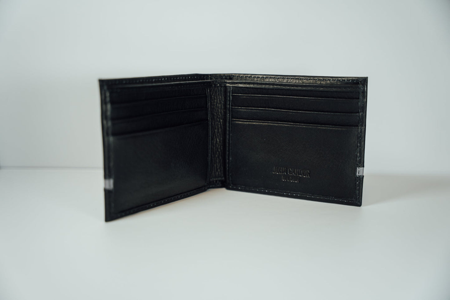 An interior view of the black and grey Slim Bifold Leather Wallet from John Candor at Hope's Gate