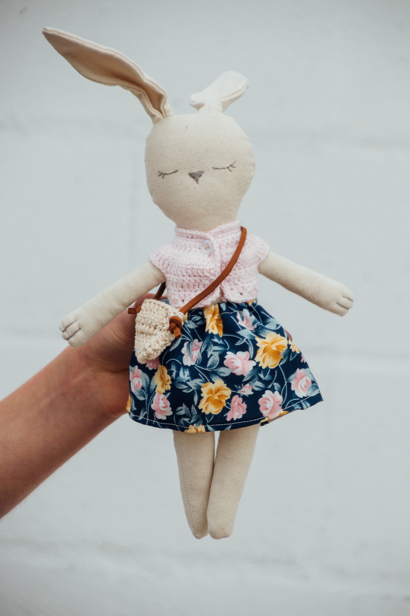 A Bunny Stuffed animal wearing a blue floral skirt and pink crocheted top from Hope's Gate