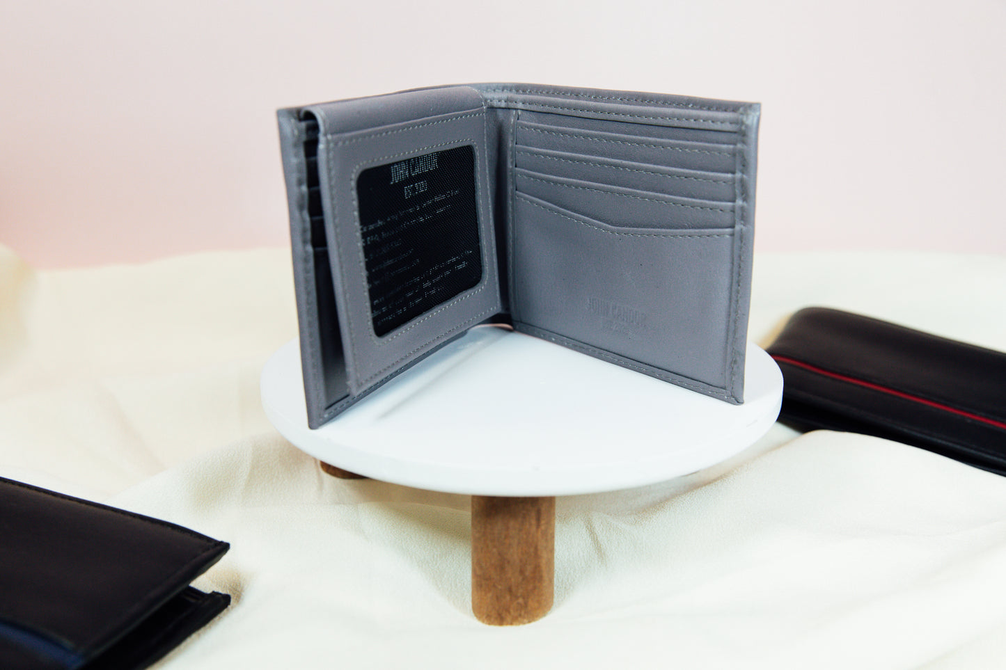 A grey Carry-It-All Leather Bifold Wallet from John Candor