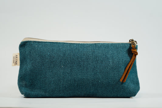 A blue fabric pencil case with a metal zipper and a leather tassel, against a white background.