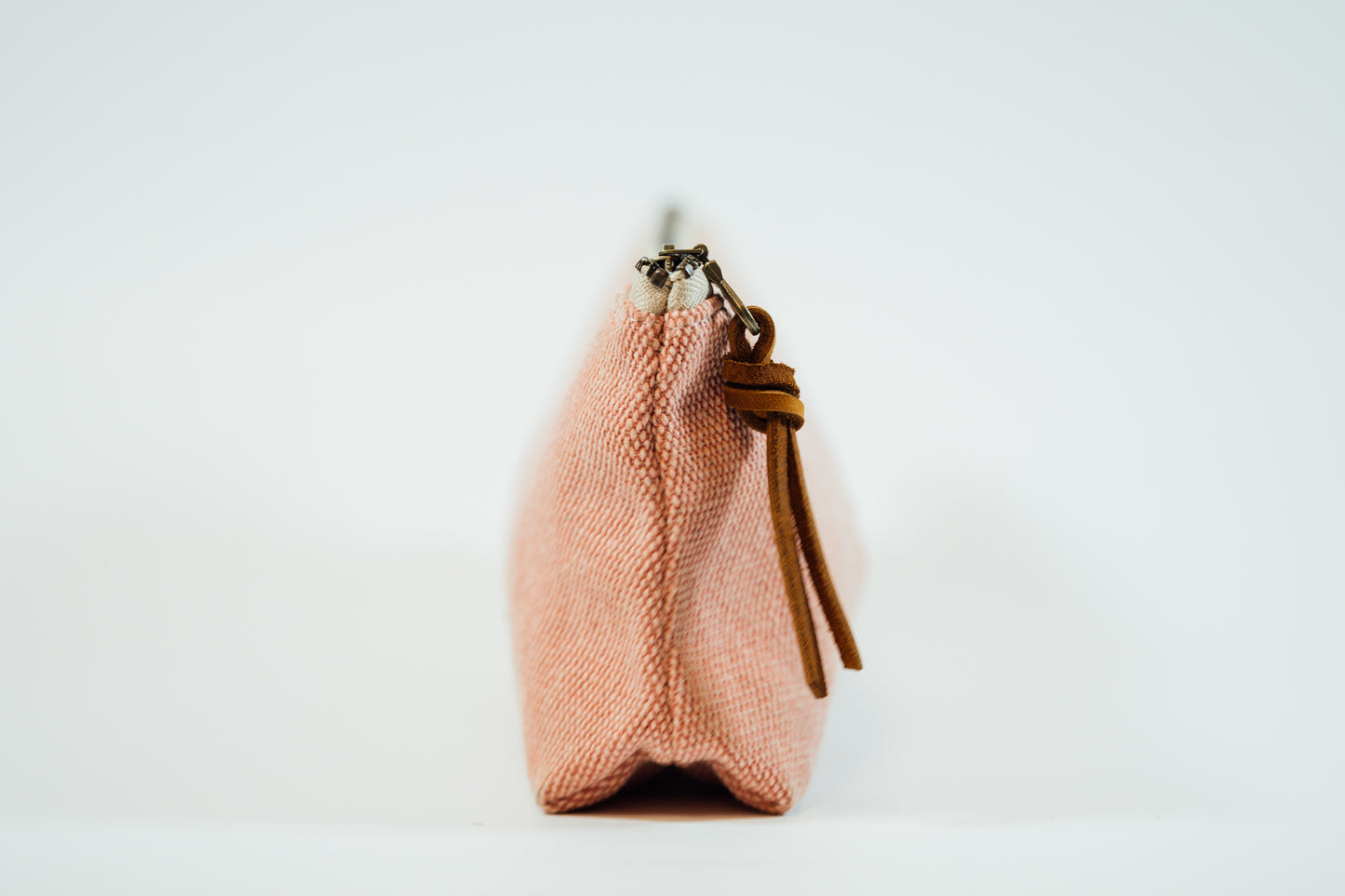 The side view of a pink fabric pencil case