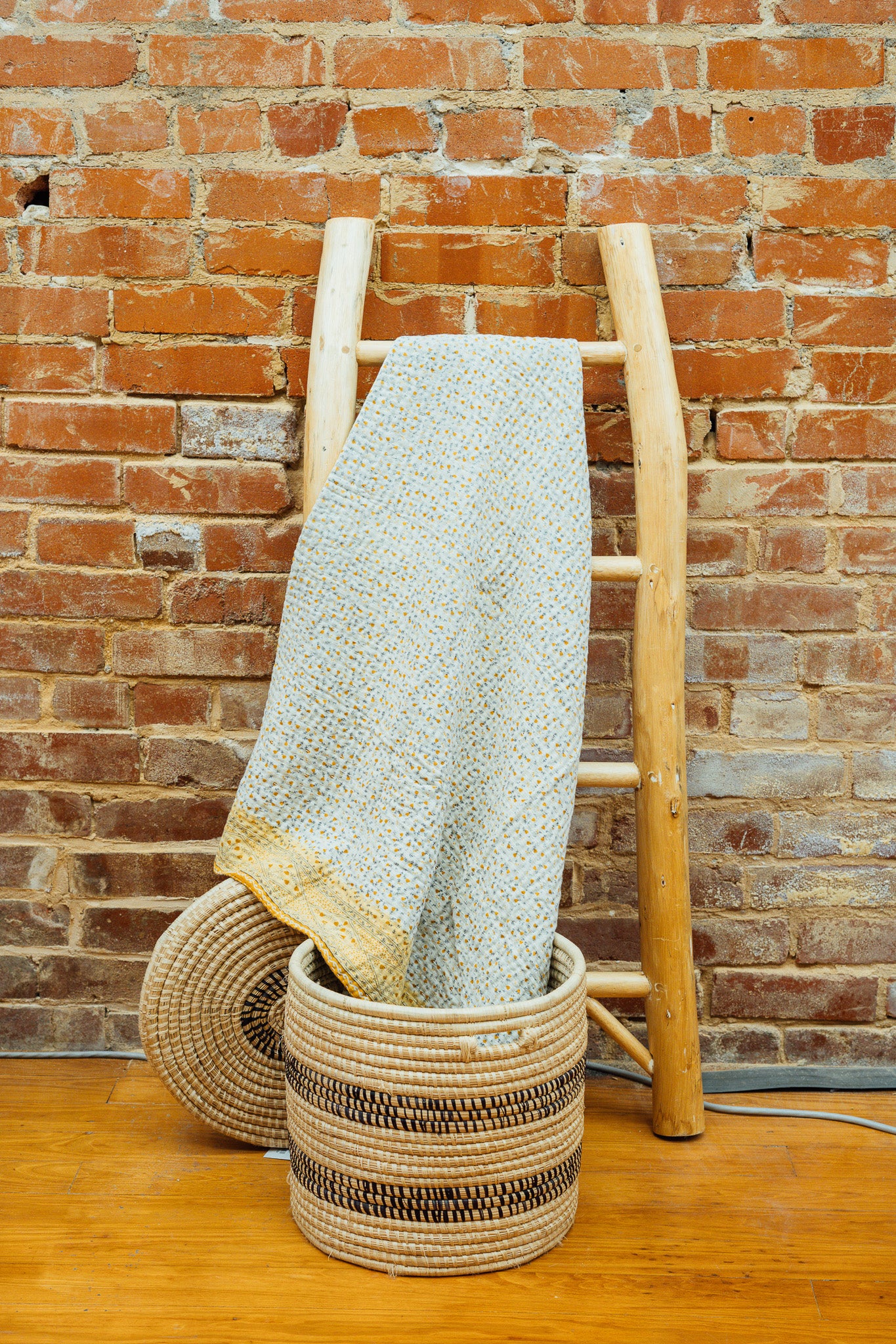 A yellow floral kantha baby blanket
