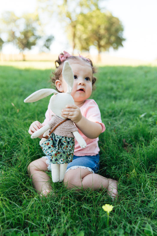 A Bunny Stuffed animal wearing a green skirt and tan crocheted top from Hope's Gate