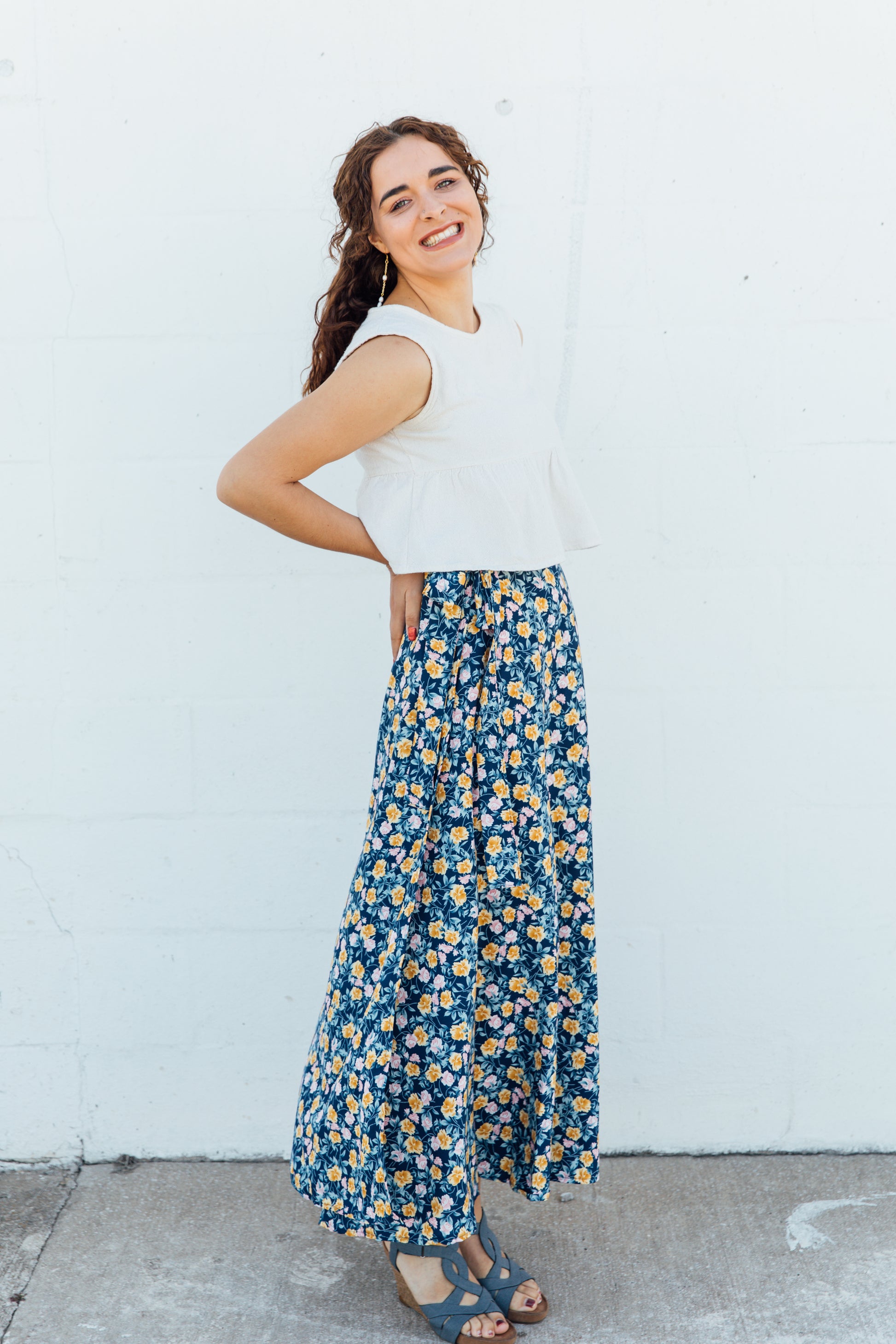 A women wearing blue floral maxi wrap skirt. 
