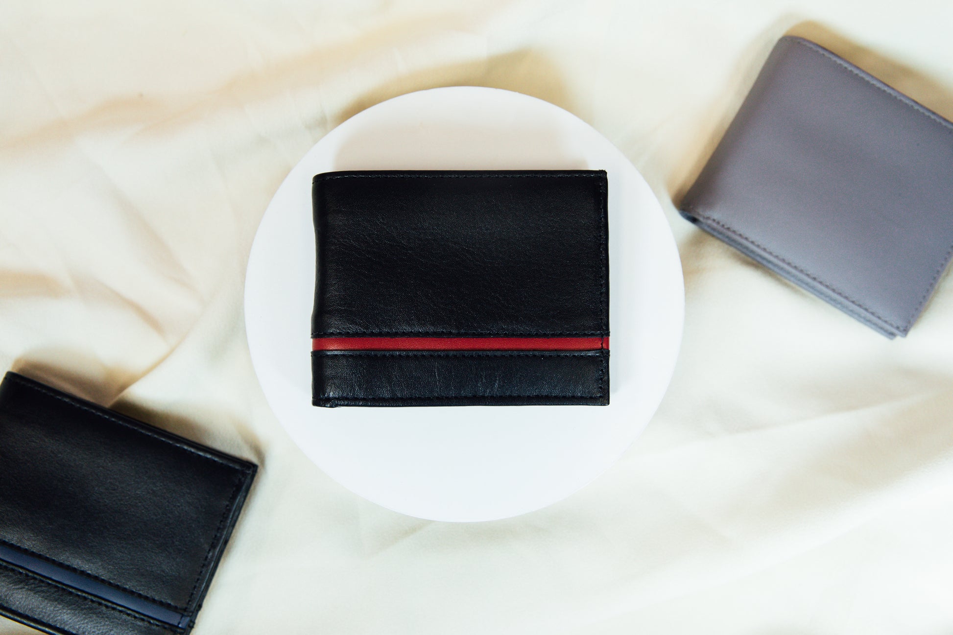 An exterior view of the black and red Carry-It-All Leather Bifold Wallet