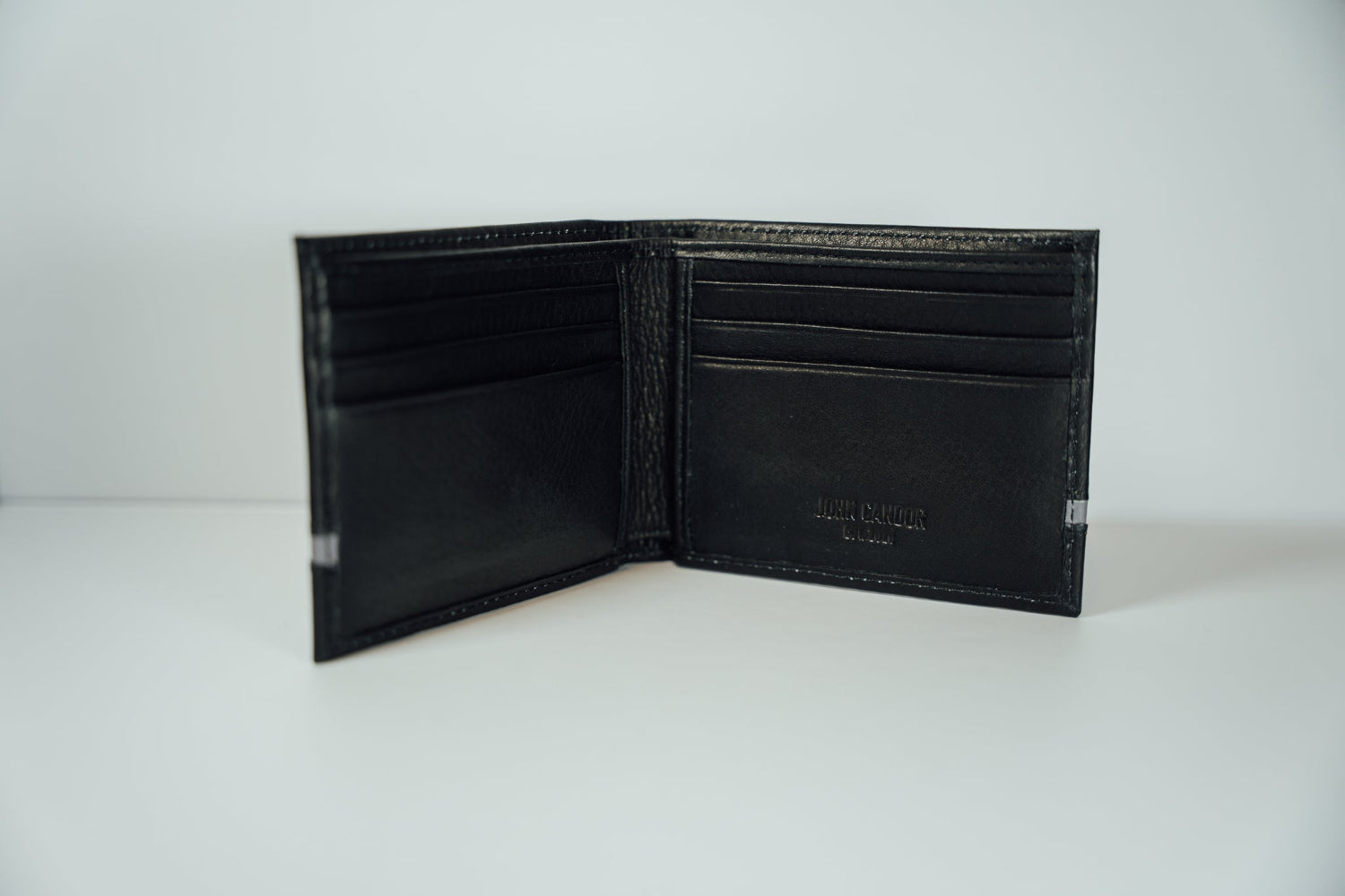 An interior view of the black and grey Slim Bifold Leather Wallet from John Candor at Hope's Gate