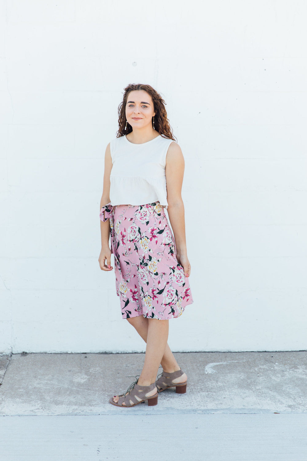 A woman wearing a pink floral midi wrap skirt