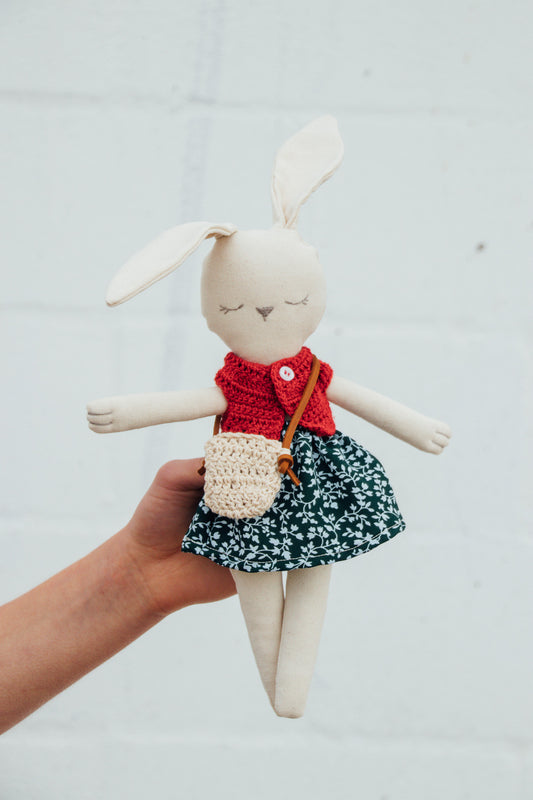 A Bunny Stuffed animal wearing a green floral skirt and red crocheted top from Hope's Gate