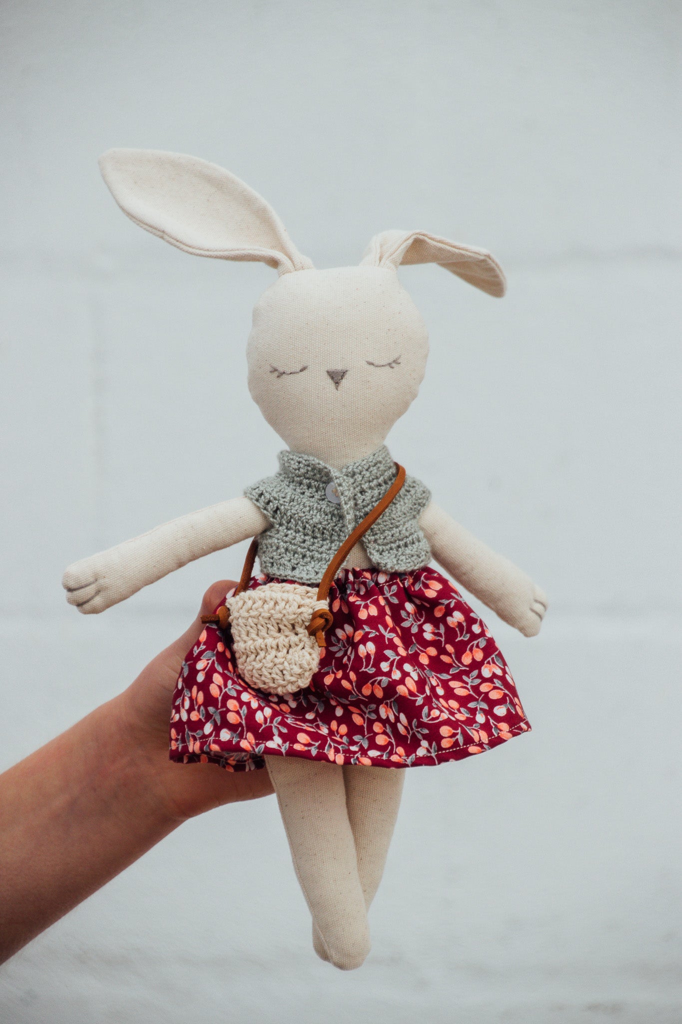 A Bunny Stuffed animal wearing a red floral skirt and green crocheted top from Hope's Gate