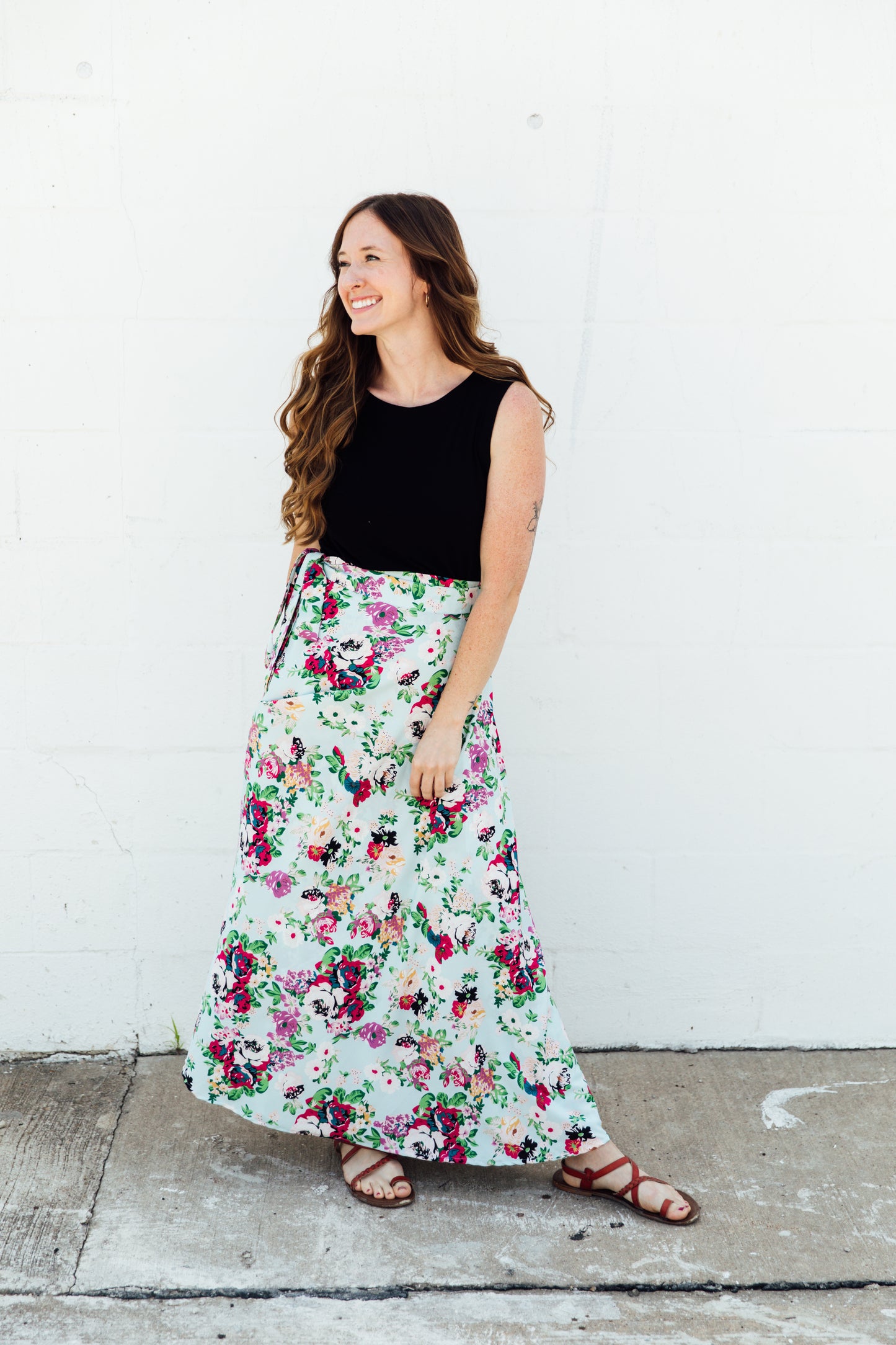 A women wear a blue floral maxi wrap skirt