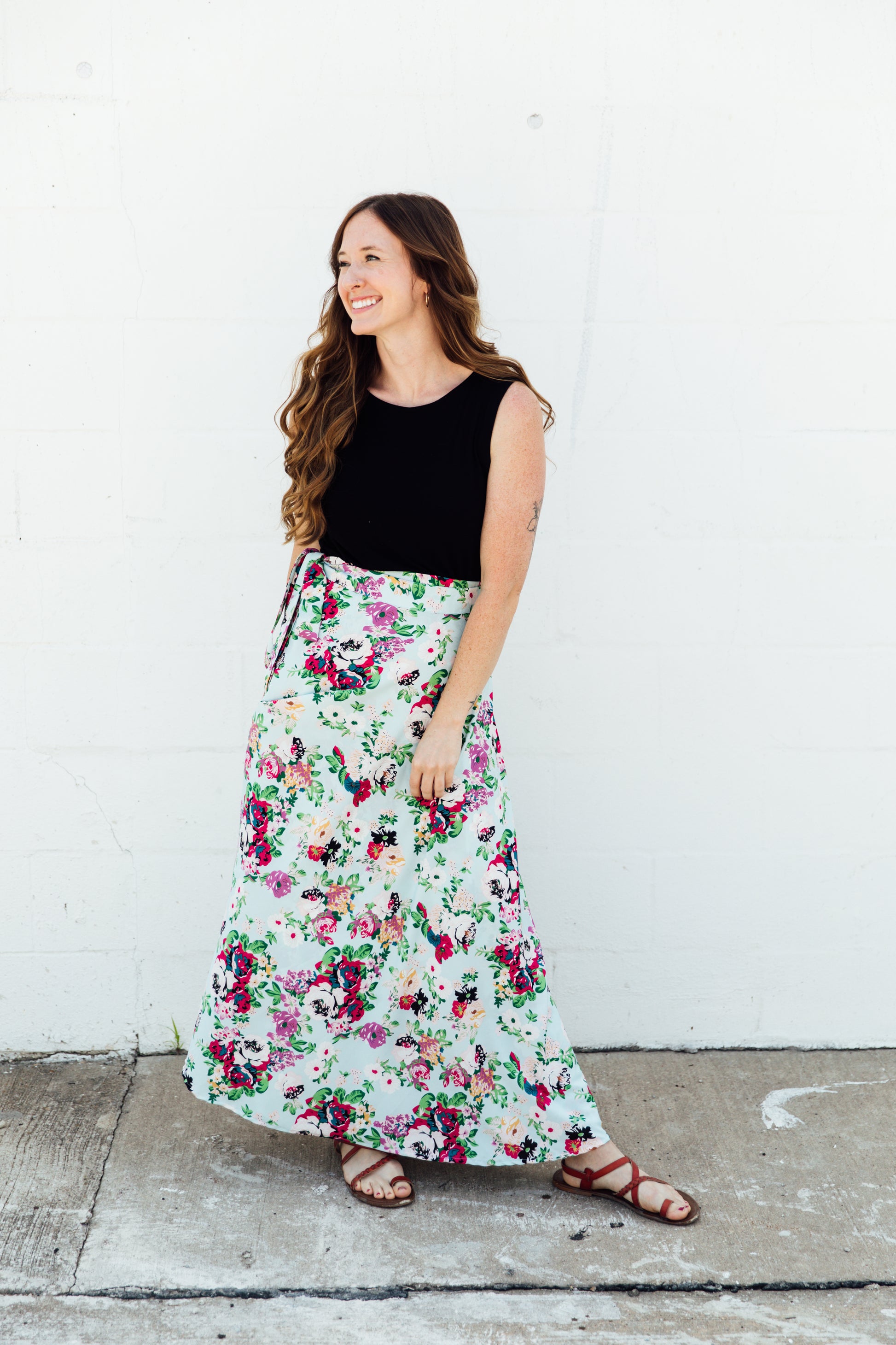 A women wear a blue floral maxi wrap skirt