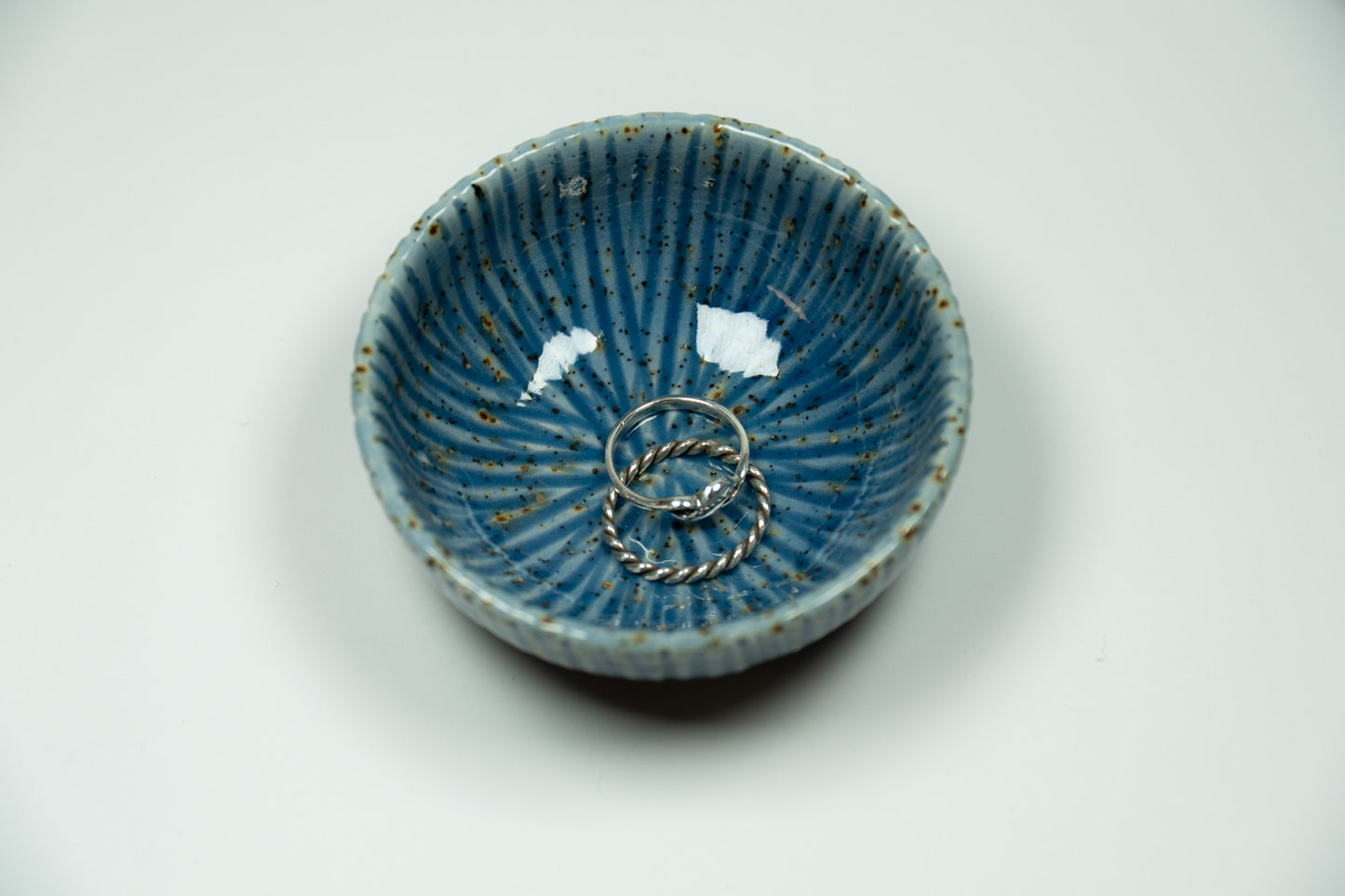 Blue ceramic bowl with decorative patterns on a white background