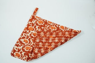 A hand-stitched Red and white block-print hand towel with a loop for hanging.