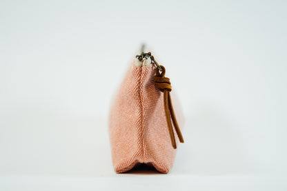 The side view of a pink fabric pencil case 