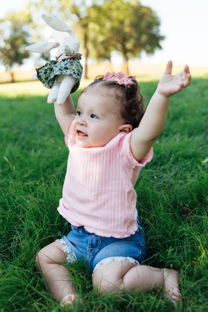 A Bunny Stuffed animal wearing a green floral skirt and tan crocheted top from Hope's Gate